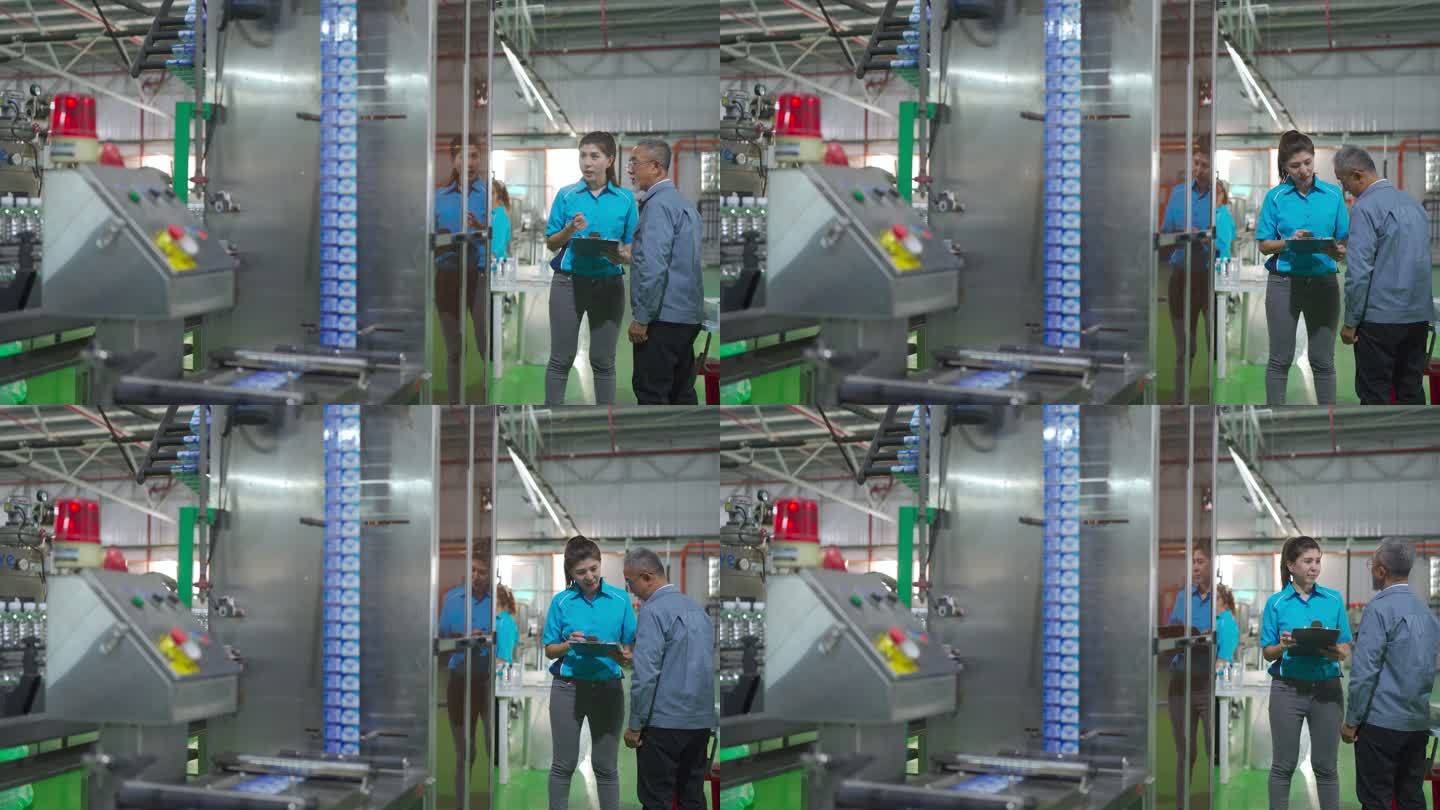 亚裔中国装瓶厂厂长与生产线工长就检查表和饮用水生产进度进行沟通